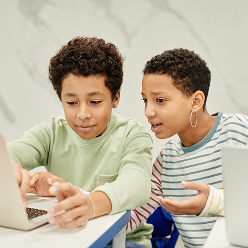 Two AA kids using Computer in Class