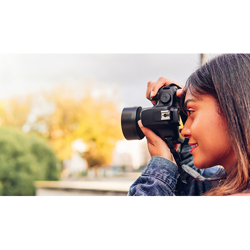 Photographer woman taking a picture with her camera.